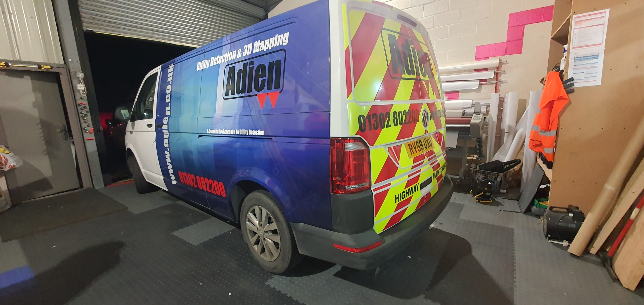 Commercial van with branded fleet graphics and reflective rear chevrons.